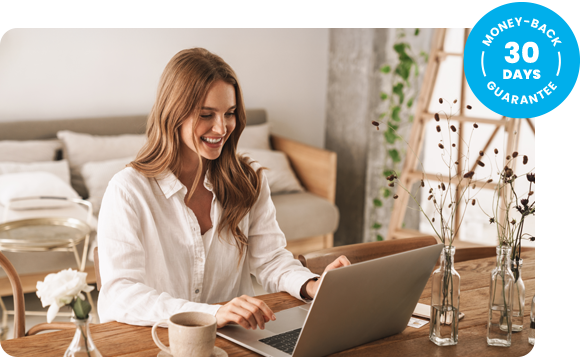 Smiling woman working on a laptop with a badge next to her reading ‘30-day money-back guarantee.’